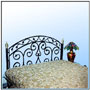 Monolithic rustic heavy construction in non circular iron, wrought to a balanced design with a rich crown band. The hand wrought construction, well suited to fine machined tubular columns to an aesthetic ensemble.  Sizes: W : 5.5'  H : 4.5'  WT : 55 lbs (Bed Head)