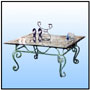 Coffee table   Hand forged; Hot wrought Victorian coffee table with deep beveled edge glass top. Entire wrought work bonderised and rust protected prior to the application of matt antiqued finish. A piece out of "Magnolia" range.  Sizes: H : 17"  W : 29"  L : 29"  WT : 35 lbs (Without Glass Top).   Entire Construction in 1/2" Solid Stock. Top frame in matching 1/2" Sq. Tubing.      