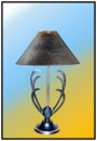 Bed Side Lamp / Corner Table Lamp     A unique "Sparrow" piece with stem and an absolutely striking moulded motif. The fine brass trim in the base adds to the intrinsic value.     Sizes: H : 18"  W : 7.5"  WT : 6.6 lbs    5.5" dia Deep Profiled Base with Polymer Coated Scratch Brass Trim.  Aesthetic balanced Twin face alloy Motif.  Stem 1/2"; Scratched brass/ S.S.    